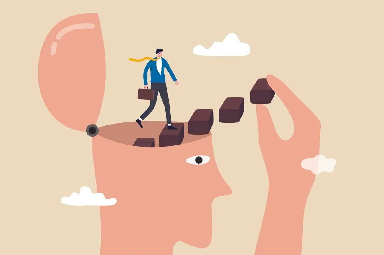 A man climbs steps emerging from an open head, symbolizing personal growth and self-improvement.