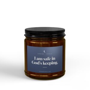Close-up of a brown glass jar with a black ridged lid and a blue label showing the text, 'I am safe in God's keeping.'