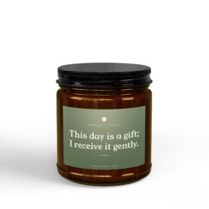 Close-up of a brown glass jar with a black screw-on lid and a green label reading, 'This day is a gift; I receive it gently.'