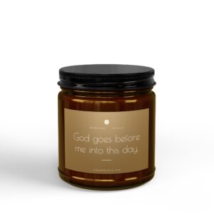 Close-up of an amber glass bottle with a black screw-cap, beige label showing the text 'Good goes before me into this day.'