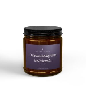 Close-up of a brown glass jar with a black screw cap and a purple label showing the text 'Evening Exhale' and 'release the day into God's hands'.