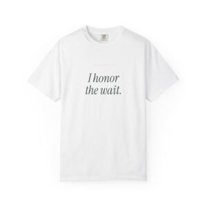 White T-shirt with a small brand tag; text on shirt reads 'I honor the wait.' (informational image)