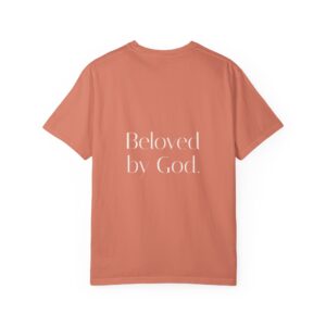 Back view of a terracotta T-shirt laid flat with large white script text reading 'Beloved by God' across the back.