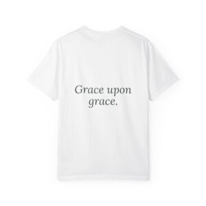 White T-shirt shown from the back with the phrase “Grace upon grace.” printed in dark script across the chest area.