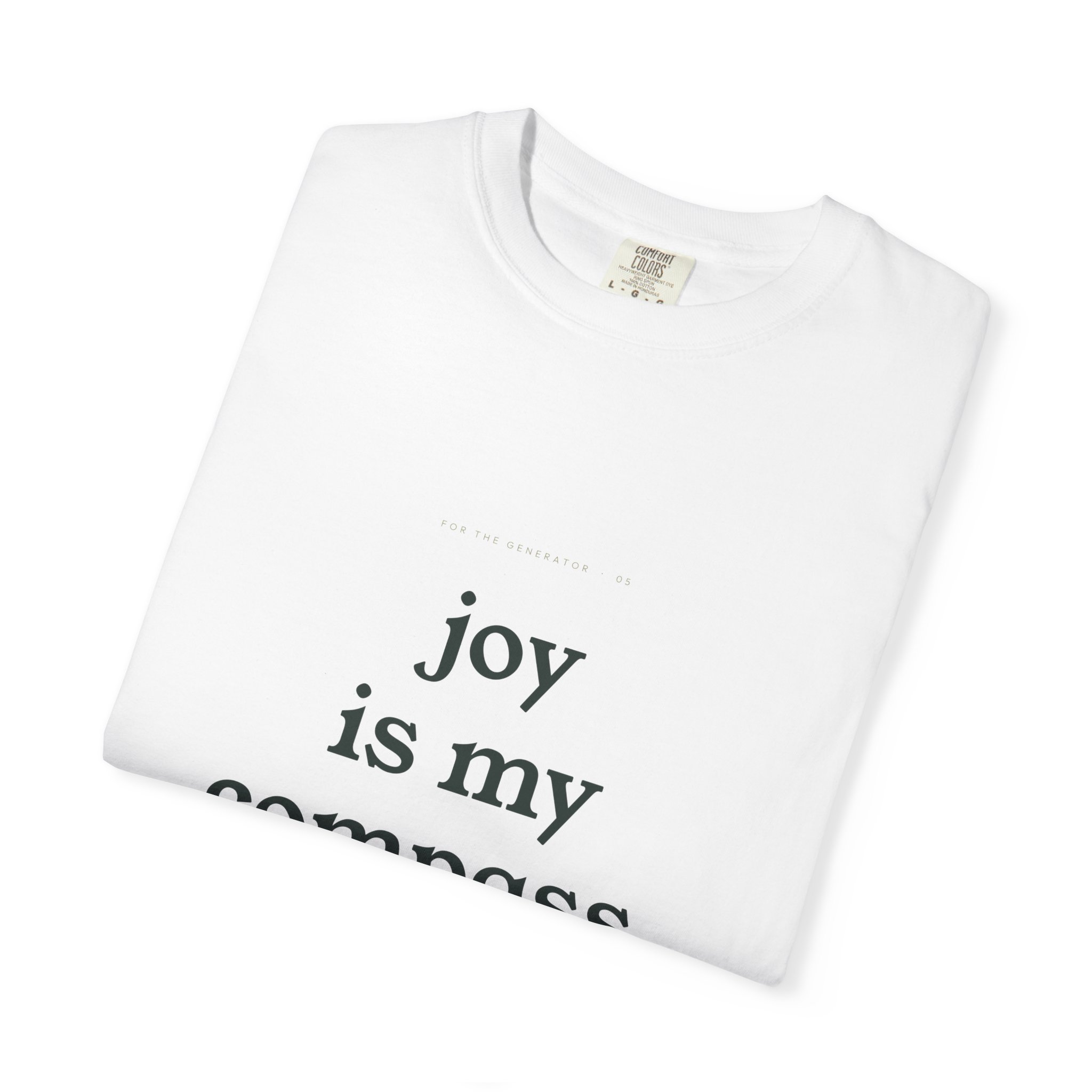 White folded T-shirt with black printed text partially visible: 'joy ...'