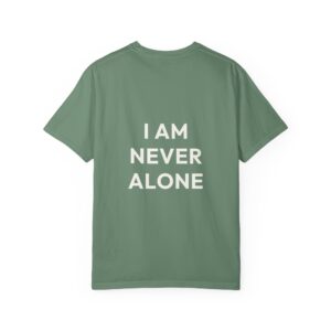 Back view of a green T-shirt laid flat with large white text; visible words read "I AM NEVER" (rest cut off) due to cropping.